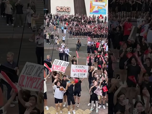 SOTA students cheer for Team Singapore Olympians as bus parade passes by