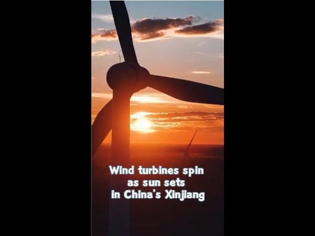 ⁣Wind turbines spin as sun sets in China's Xinjiang