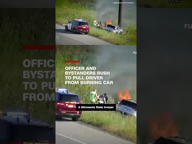 ⁣Officer and bystanders rush to pull driver from burning car