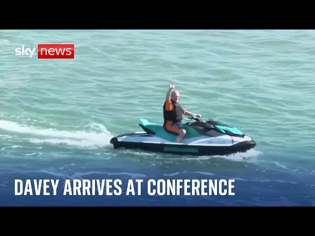 ⁣Sir Ed Davey arrives at Lib Dem conference on a jet ski