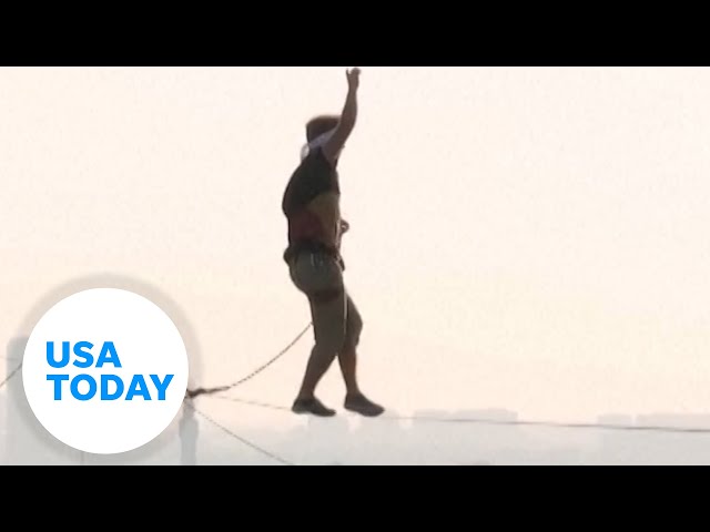 ⁣Estonian man slacklines across bridge connecting Asia to Europe | USA TODAY