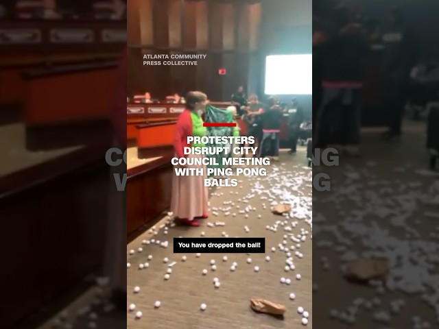 ⁣Protesters disrupt city council meeting with ping pong balls