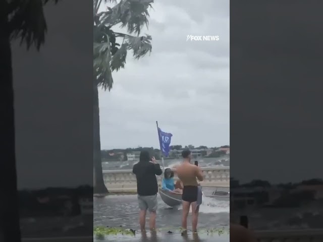 ⁣Pro-Trump boaters speed down flooded streets before Hurricane Helene makes landfall