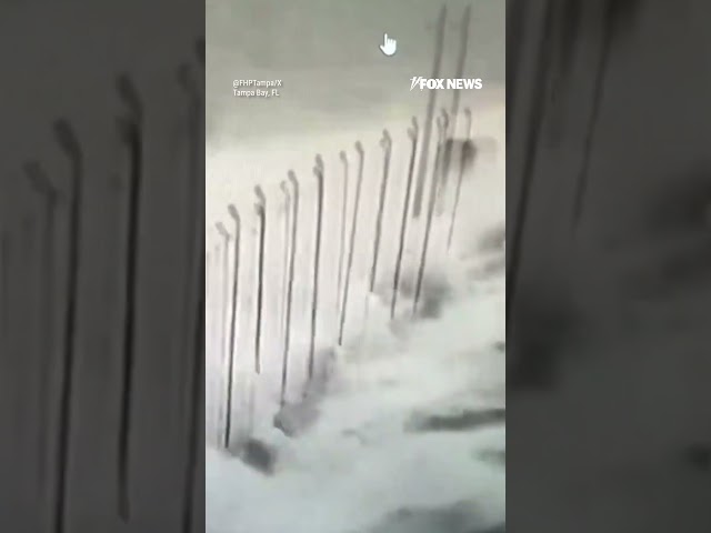 ⁣Video shows cars driving across Florida bridge as dangerous waves from Helene crash onto road