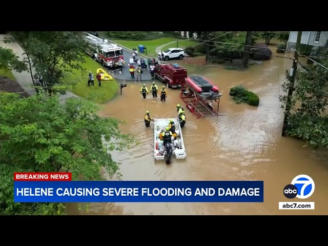 ⁣Catastrophic flooding from Hurricane Helene forces people to seek safety on rooftops