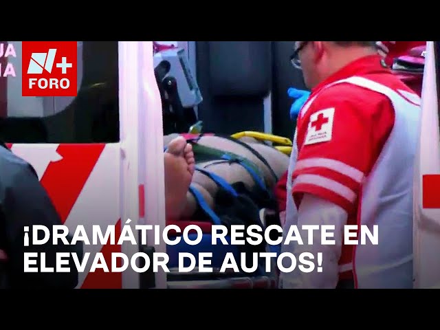 ⁣Rescatan a 2 hombres prensados en un elevador de vehículos en la CDMX - Las Noticias