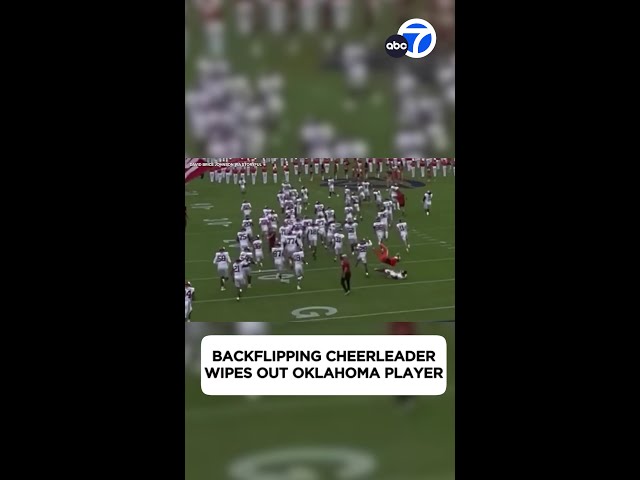 ⁣WHOOPS! Backflipping cheerleader wipes out football player