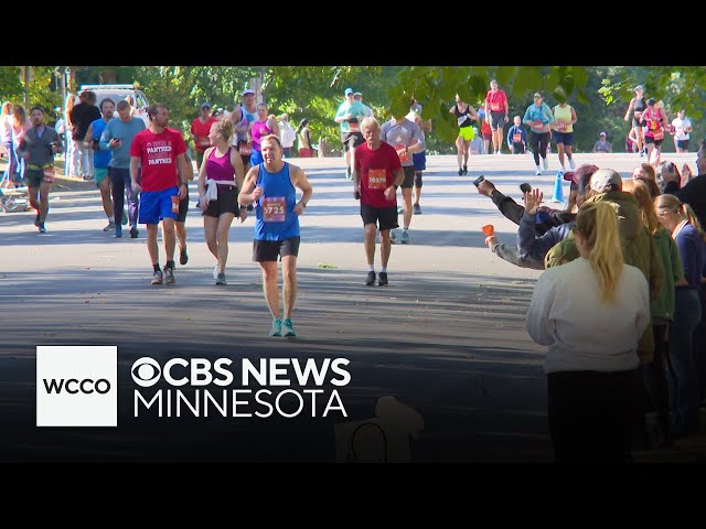 ⁣Volunteer runners help to cheer on Twin Cities Marathon participants