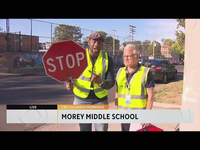 ⁣CBS Colorado's Justin Adams helps students cross the street as a celebrity crossing guard