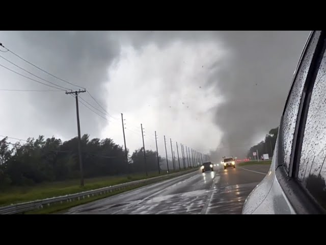 ⁣Broken power lines flash as tornado spins across road in Florida