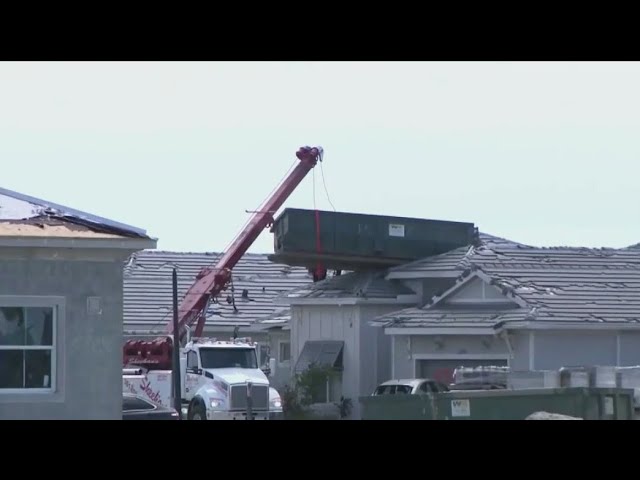 ⁣Hurricane Milton winds blow dumpster onto home's roof