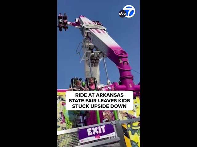 ⁣Mother films scary moment her kids get stuck upside down on carnival ride