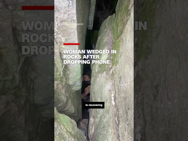 ⁣Woman wedged in rocks after dropping phone