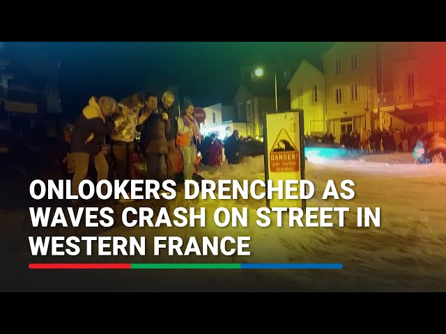 ⁣Onlookers drenched as waves crash on street in western France