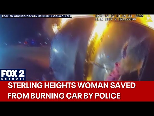 ⁣Police bodycam captures heroic rescue from burning car