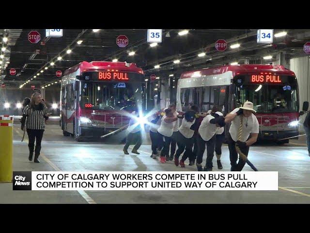 ⁣City of Calgary employees pull bus for charity