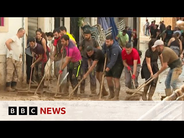 ⁣Thousands of volunteers help with clean up in flood-hit Valencia | BBC News