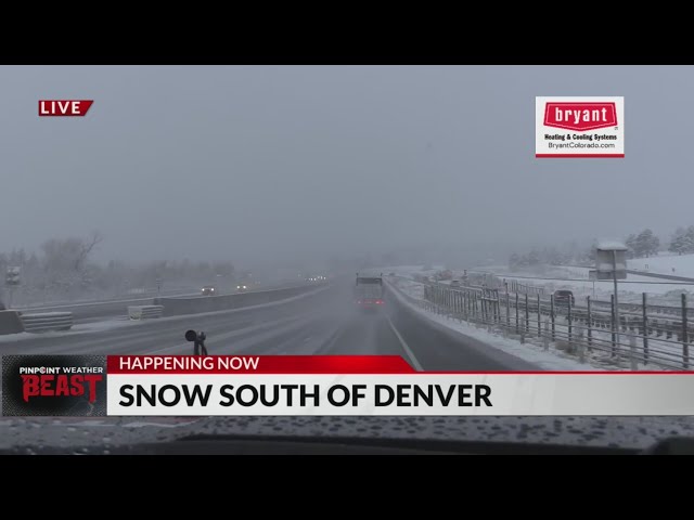 ⁣Snow falls on roads south of Denver