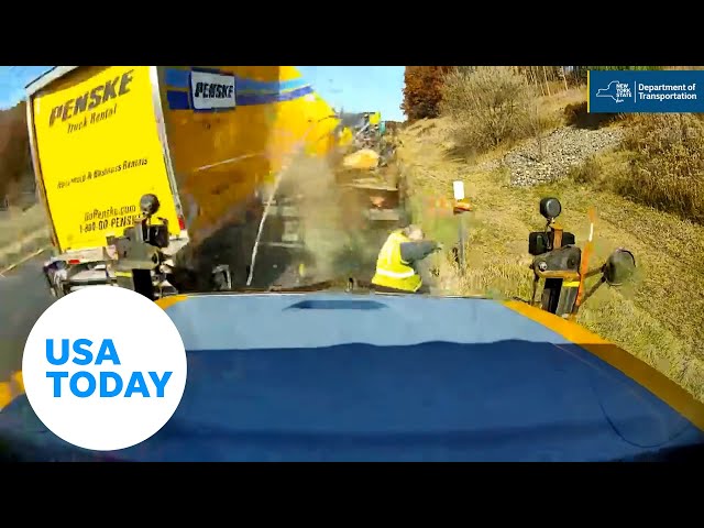 ⁣Road worker dodges truck before it crashes along highway | USA TODAY