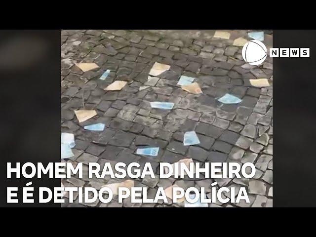 ⁣Homem é contido pela polícia após rasgar e jogar dinheiro pela janela