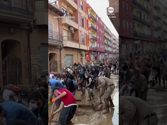 ⁣Volunteers sweep water after deadly Spain floods