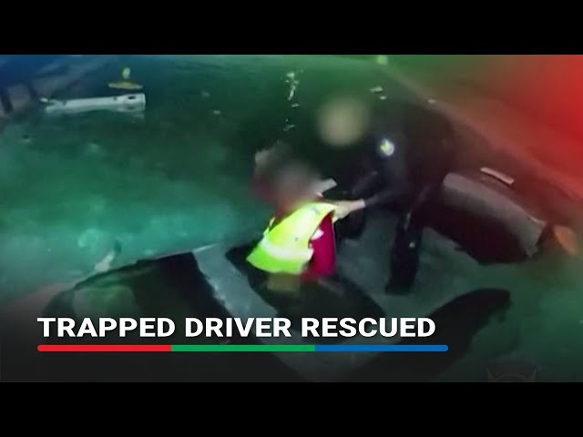 ⁣Police bodycam shows rescue of driver trapped in submerged car