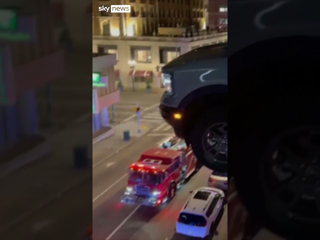 ⁣Car hangs from third floor of car park