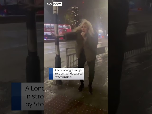 ⁣Woman loses umbrella to Storm Bert