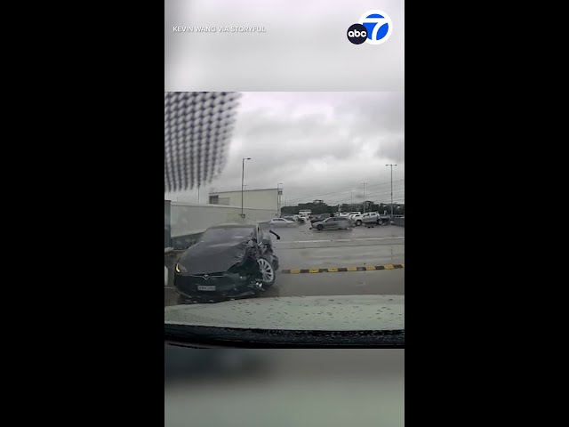 ⁣Runaway Tesla crashes into cars, drives off garage rooftop