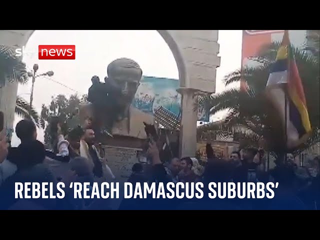 ⁣Syrian rebel forces 'reach Damascus suburbs' as protesters topple statue on outskirts