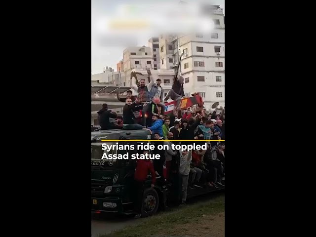 ⁣Syrians ride on toppled Assad statue | AJ #shorts