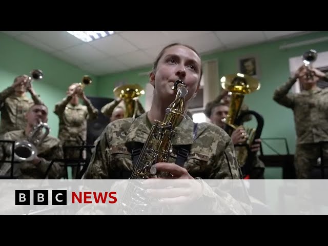 ⁣Ukrainian military band use weapons to play Christmas carols | BBC News