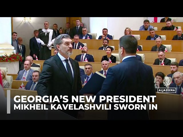 ⁣New Georgian president sworn in as predecessor refuses to stand aside