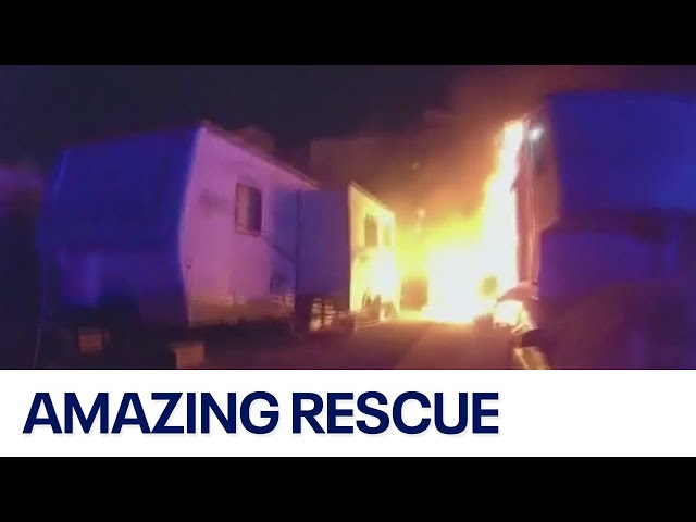 ⁣Dramatic video shows police rescue man from burning trailer