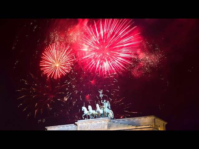 ⁣Happy New Year! Fireworks explode in the sky above the Quadriga on the Brandenburg Gate in Berlin