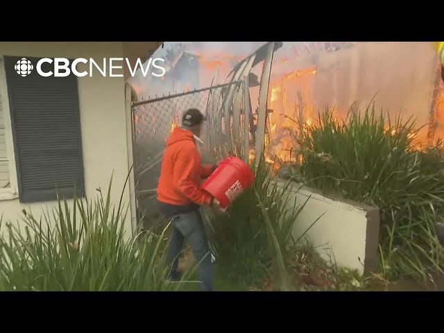 ⁣Watch L.A. residents fight to save a home from raging fires