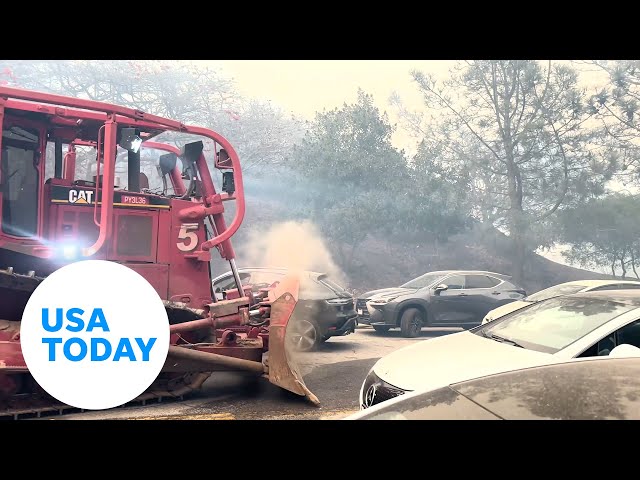 ⁣Watch: Bulldozer clears cars amid Palisades Fire in Los Angeles