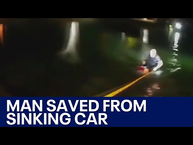 ⁣Dramatic rescue of man trapped in sinking car caught on camera