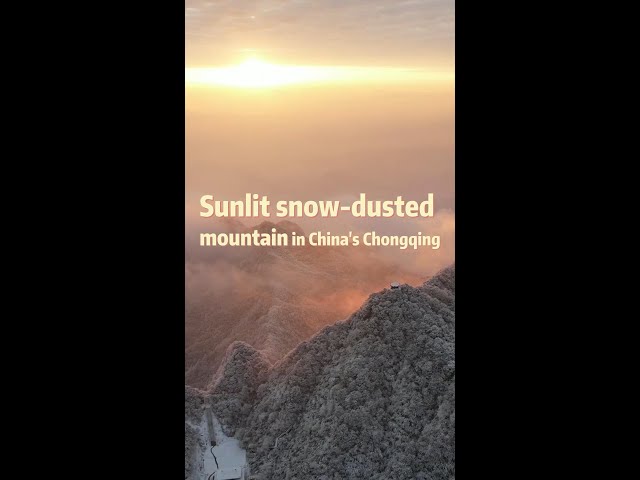 ⁣Sunlit snow-dusted mountain in China's Chongqing