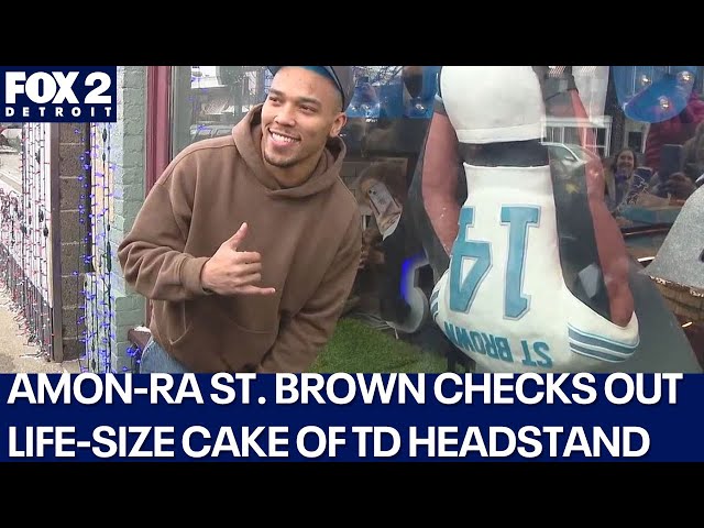 ⁣Lions' Amon-Ra St. Brown checks out Rochester bakery's life-size cake of his TD celebratio